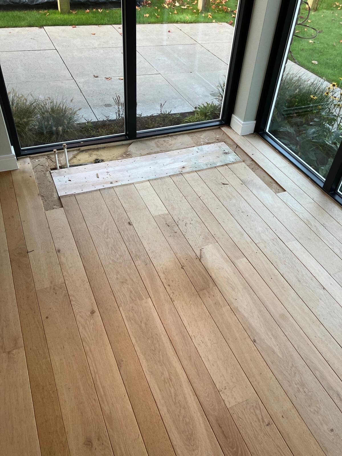 Aanhelen, bijleggen van houten vloer na verbouwing verwijderen convectorput Gorinchem.jpg